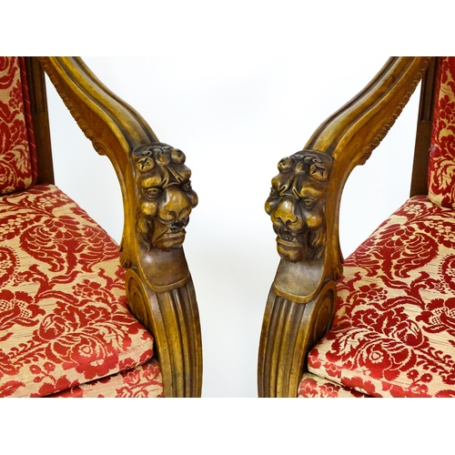 1497 - A pair of 19thC continental mahogany armchairs surmounted by corbel style reeded mounts and lions ma... 