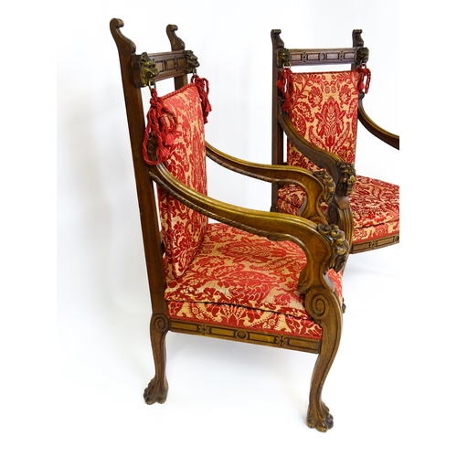 1497 - A pair of 19thC continental mahogany armchairs surmounted by corbel style reeded mounts and lions ma... 