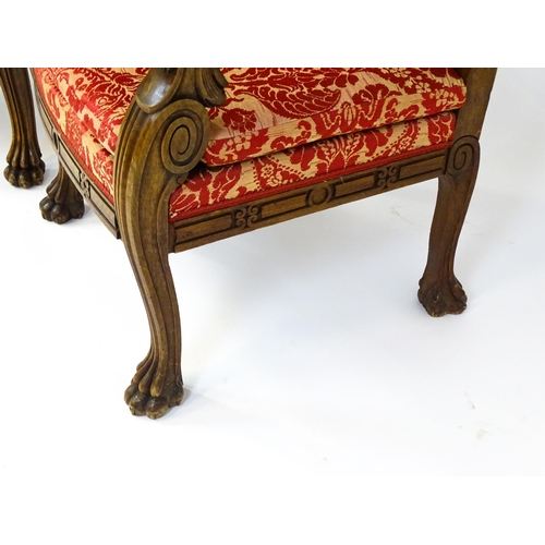 1497 - A pair of 19thC continental mahogany armchairs surmounted by corbel style reeded mounts and lions ma... 