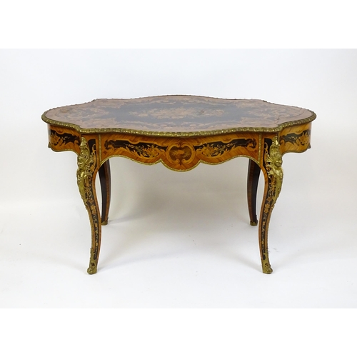 1498 - A 19thC kingwood centre table with a marquetry inlaid top having satinwood, mahogany, walnut and oth... 