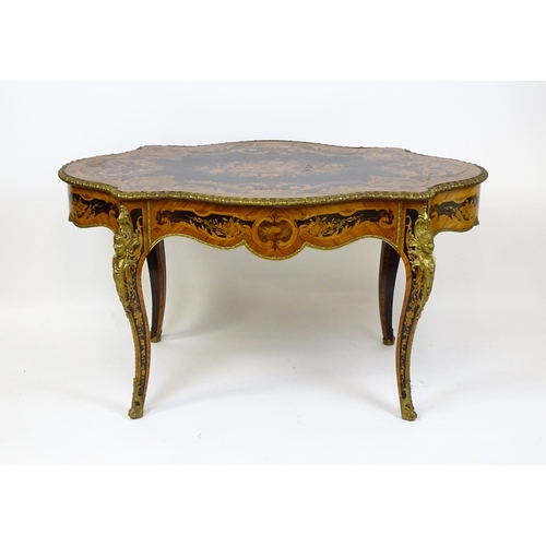 1498 - A 19thC kingwood centre table with a marquetry inlaid top having satinwood, mahogany, walnut and oth... 