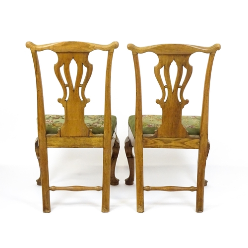 1499 - A pair of George II walnut side chairs with shaped top rails above pierced splats and raised on shap... 