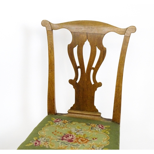 1499 - A pair of George II walnut side chairs with shaped top rails above pierced splats and raised on shap... 