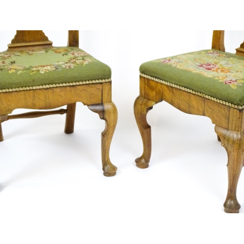 1499 - A pair of George II walnut side chairs with shaped top rails above pierced splats and raised on shap... 