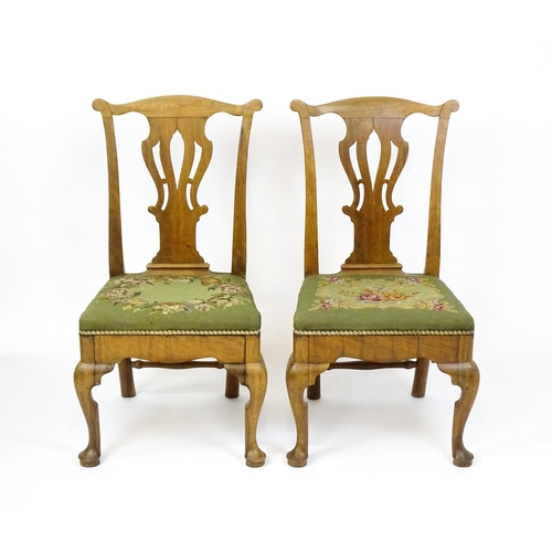 1499 - A pair of George II walnut side chairs with shaped top rails above pierced splats and raised on shap... 