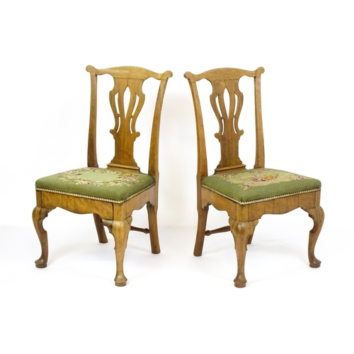 1499 - A pair of George II walnut side chairs with shaped top rails above pierced splats and raised on shap... 