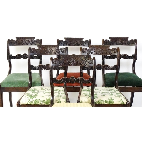 1502 - A set of six early / mid 19thC Irish dining chairs with floral and scroll carved mid and top rails a... 