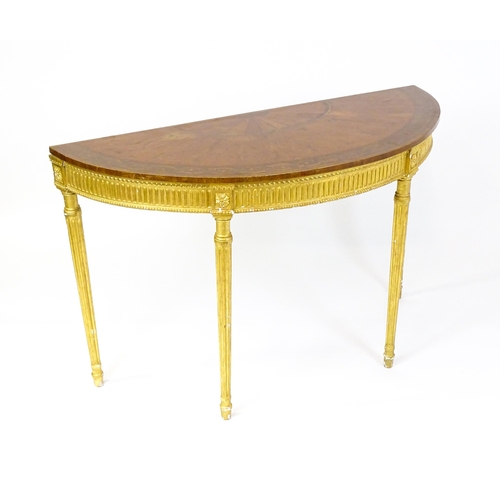 1507 - A demi lune console table with a marquetry inlaid top above a fluted frieze and moulded floral decor... 