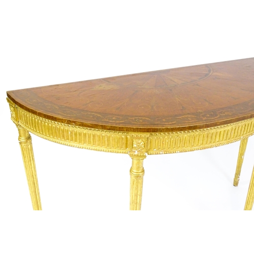 1507 - A demi lune console table with a marquetry inlaid top above a fluted frieze and moulded floral decor... 