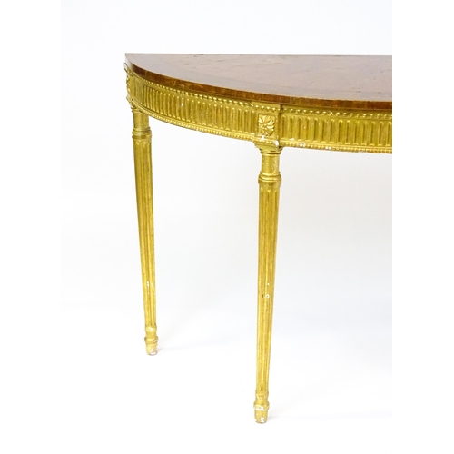 1507 - A demi lune console table with a marquetry inlaid top above a fluted frieze and moulded floral decor... 