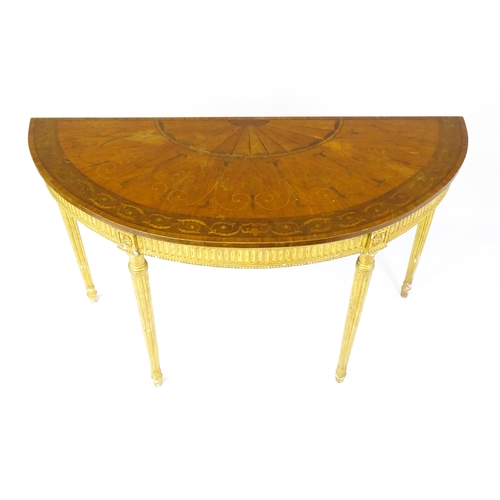 1507 - A demi lune console table with a marquetry inlaid top above a fluted frieze and moulded floral decor... 