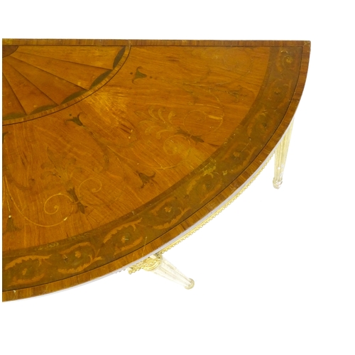 1507 - A demi lune console table with a marquetry inlaid top above a fluted frieze and moulded floral decor... 