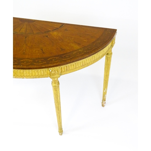 1507 - A demi lune console table with a marquetry inlaid top above a fluted frieze and moulded floral decor... 