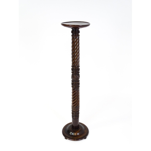 1509 - A Victorian mahogany torchiere / jardinière stand with a twist turned pedestal with carved decoratio... 