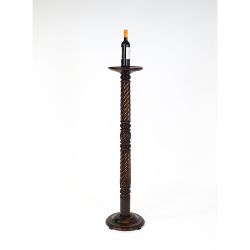 1509 - A Victorian mahogany torchiere / jardinière stand with a twist turned pedestal with carved decoratio... 