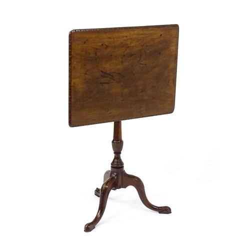 1514 - A late 18thC / early 19thC mahogany occasional table with a rectangular top and carved edge above a ... 