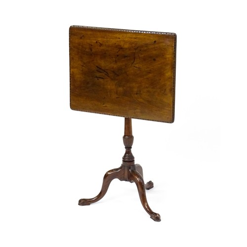 1514 - A late 18thC / early 19thC mahogany occasional table with a rectangular top and carved edge above a ... 