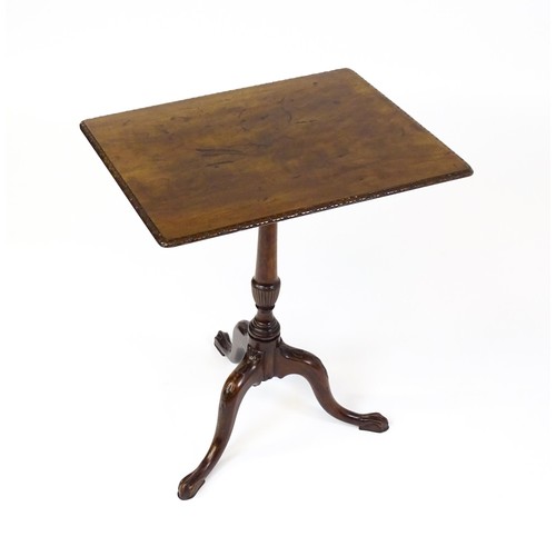 1514 - A late 18thC / early 19thC mahogany occasional table with a rectangular top and carved edge above a ... 