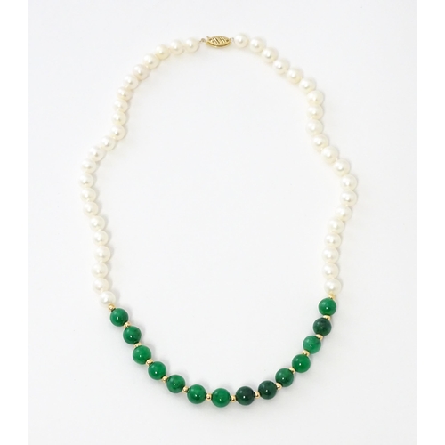 727 - A necklace of jade beads and pearls with 14ct gold clasp. Approx 18