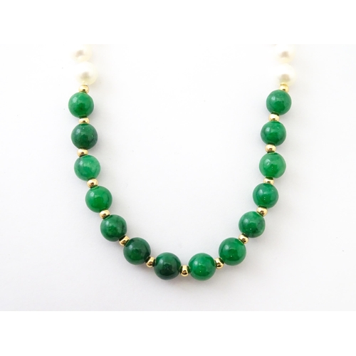 727 - A necklace of jade beads and pearls with 14ct gold clasp. Approx 18