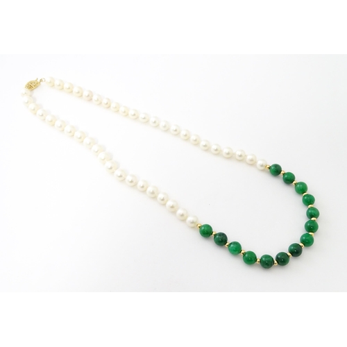 727 - A necklace of jade beads and pearls with 14ct gold clasp. Approx 18