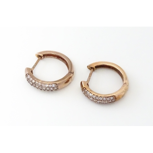 729 - A pair of 9ct rose gold earrings set with diamonds