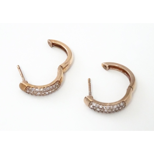 729 - A pair of 9ct rose gold earrings set with diamonds