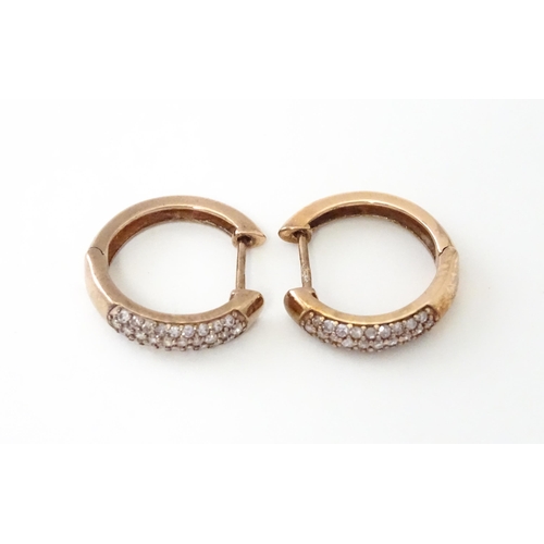 729 - A pair of 9ct rose gold earrings set with diamonds