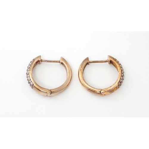 729 - A pair of 9ct rose gold earrings set with diamonds