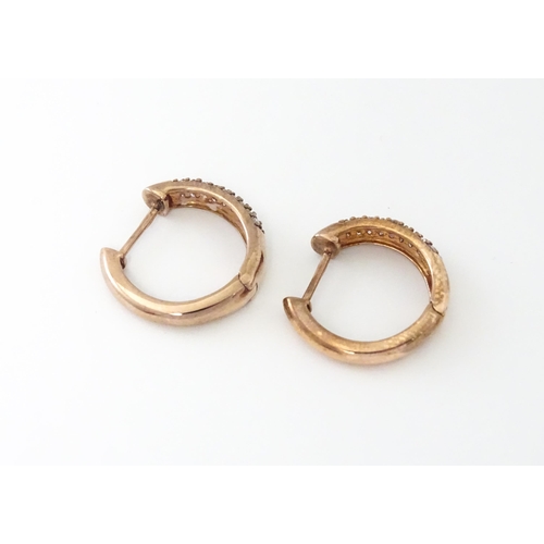 729 - A pair of 9ct rose gold earrings set with diamonds