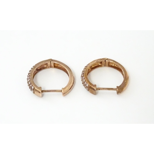 729 - A pair of 9ct rose gold earrings set with diamonds