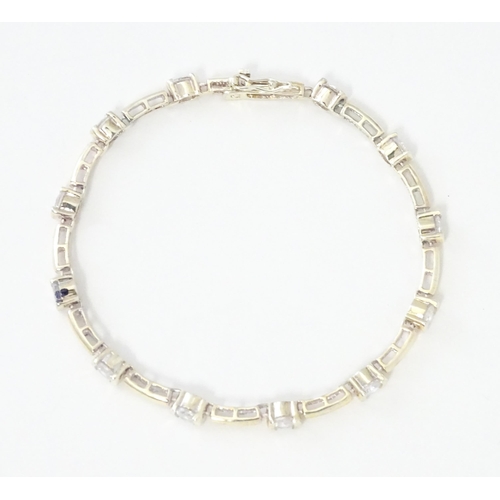 734 - A .925 Silver bracelet set with cubic zirconia. Approx 7 1/2