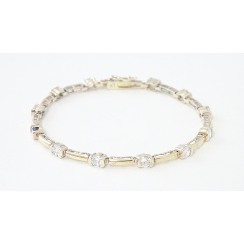 734 - A .925 Silver bracelet set with cubic zirconia. Approx 7 1/2