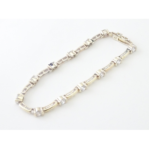 734 - A .925 Silver bracelet set with cubic zirconia. Approx 7 1/2