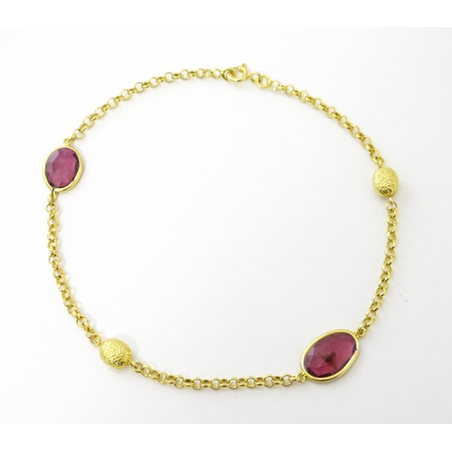 740 - A silver gilt bracelet set with pink tourmaline. Approx 8