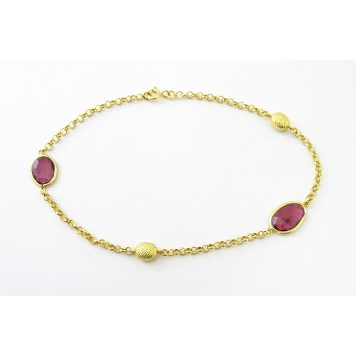 740 - A silver gilt bracelet set with pink tourmaline. Approx 8