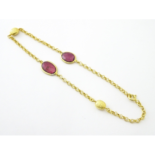 740 - A silver gilt bracelet set with pink tourmaline. Approx 8