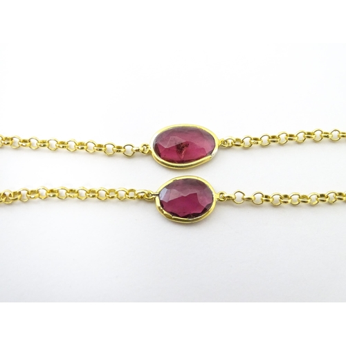 740 - A silver gilt bracelet set with pink tourmaline. Approx 8