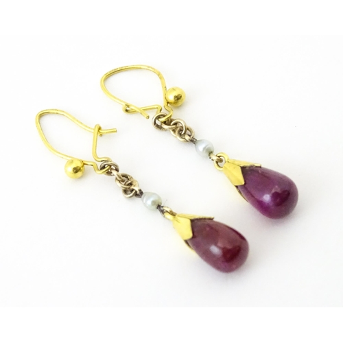 746 - A pair of 9ct gold drop earrings set with seed pearls and sapphire drops. 1 1/4