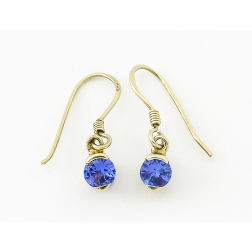 748 - A pair of silver gilt drop earrings set with tanzanites. Approx. 1/2