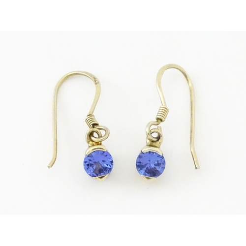 748 - A pair of silver gilt drop earrings set with tanzanites. Approx. 1/2