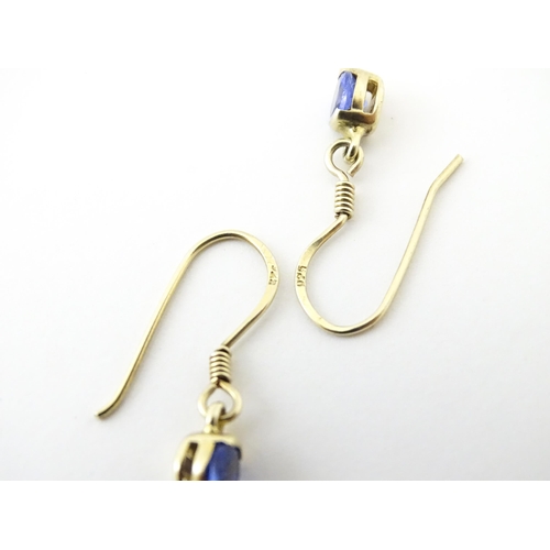 748 - A pair of silver gilt drop earrings set with tanzanites. Approx. 1/2