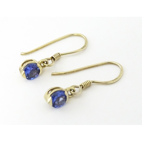 748 - A pair of silver gilt drop earrings set with tanzanites. Approx. 1/2