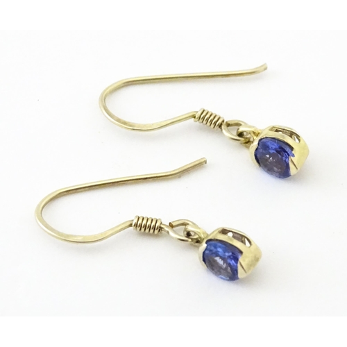 748 - A pair of silver gilt drop earrings set with tanzanites. Approx. 1/2