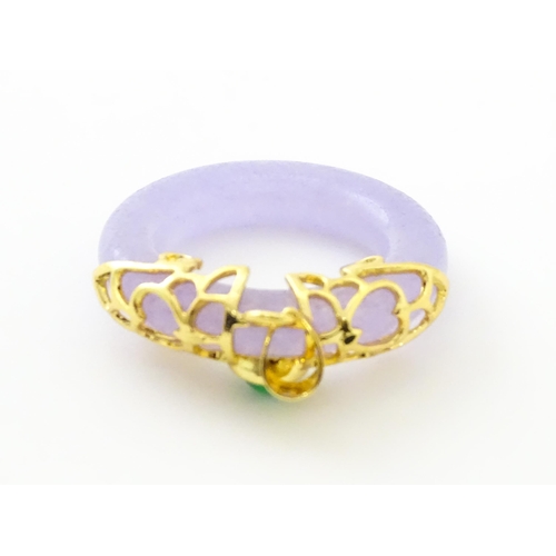 754 - A pendant with gilt metal mounts and purple coloured jade like ring detail. 1 1/2