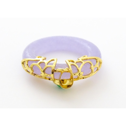 754 - A pendant with gilt metal mounts and purple coloured jade like ring detail. 1 1/2