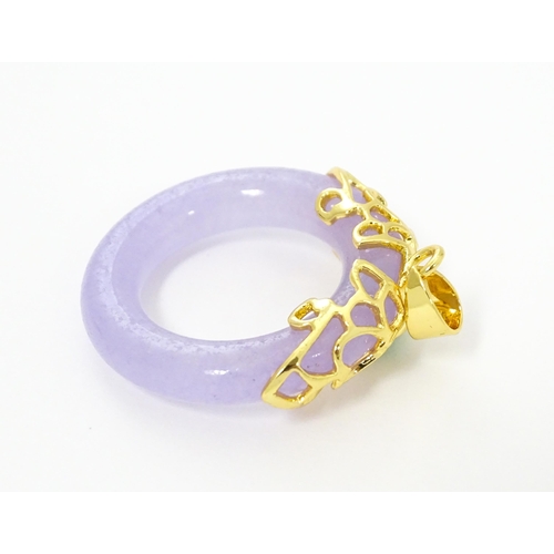 754 - A pendant with gilt metal mounts and purple coloured jade like ring detail. 1 1/2