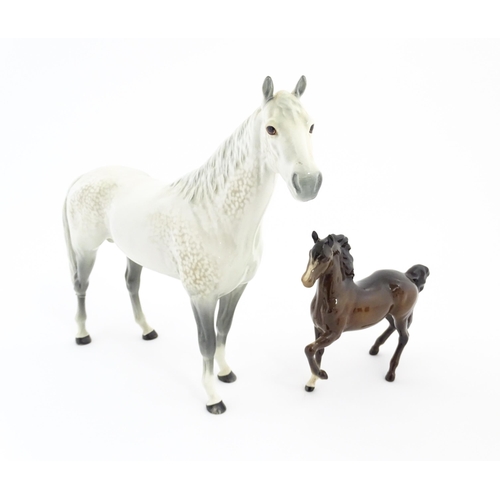 124 - A large Beswick dapple grey hunter horse. Together with a Beswick brown jogging mare. Marked under. ... 