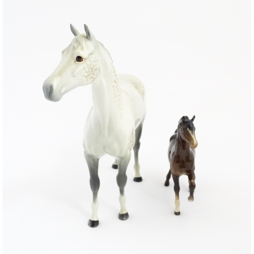 124 - A large Beswick dapple grey hunter horse. Together with a Beswick brown jogging mare. Marked under. ... 