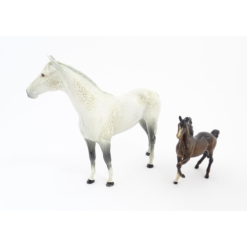 124 - A large Beswick dapple grey hunter horse. Together with a Beswick brown jogging mare. Marked under. ... 